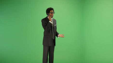 Annoyed-Businessman-talking-on-phone-with-green-screen